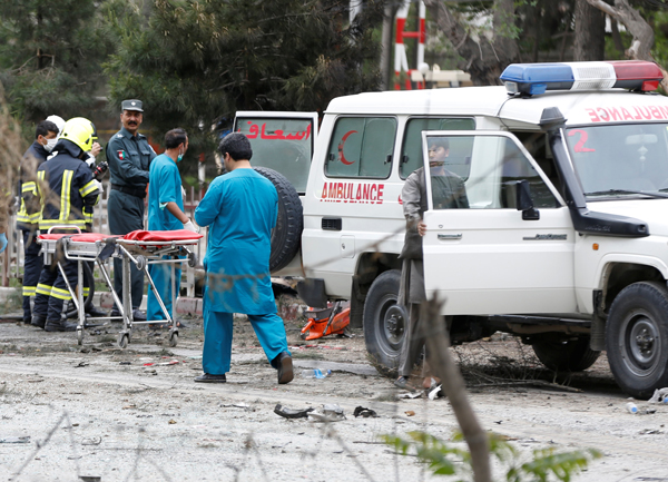 Afghan security forces and medics are seen at the site of a suicide attack in Kabul